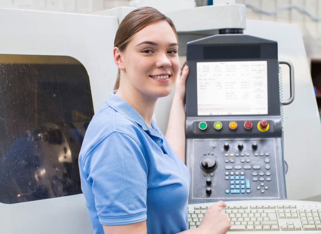Female Operating CNC Machine In Factory