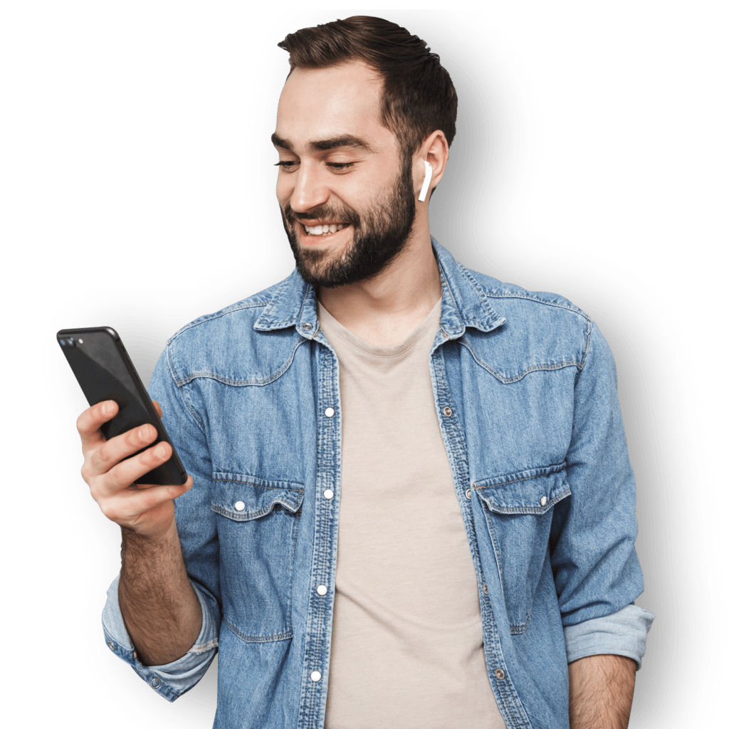 Excited cheerful man wearing shirt standing using phone
